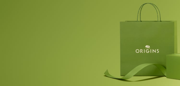 beige background with brown gift boxes with green ribbon